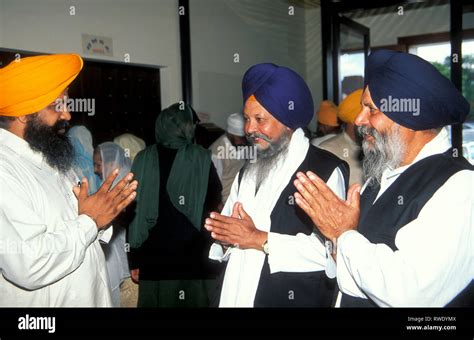 Sikh Businessmen Greet Each Other After Worship In The Gurdwara Stock