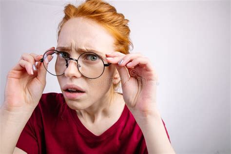 Shocked Woman Looking At Camera With Open Mouth And Touching Glasses