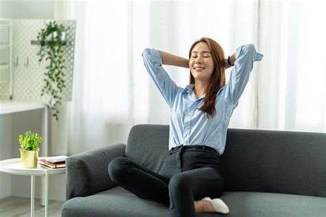 Happy Asian Woman Relaxing Sitting On Sofa At Home Work From Home