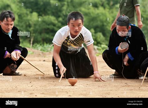 Traditional spinning top (Tujlub) competition action at a Hmong new year festival at Hung Saew ...