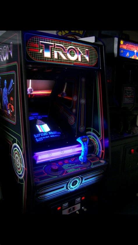 An Arcade Machine In The Dark With Neon Lights