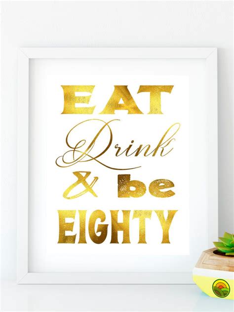 A Framed Print With The Words Eat Drink And Be Eighty In Gold Foil On It