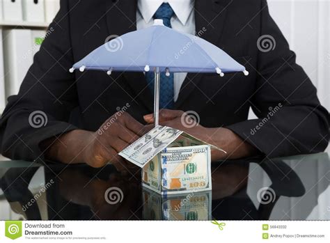 Businessman Protecting House With Umbrella Stock Photo - Image of black, desk: 56843332