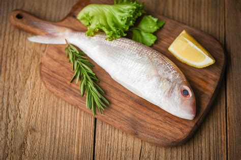 Fresh Raw Fish With Ingredients Lemon Rosemary And Lettuce For Making