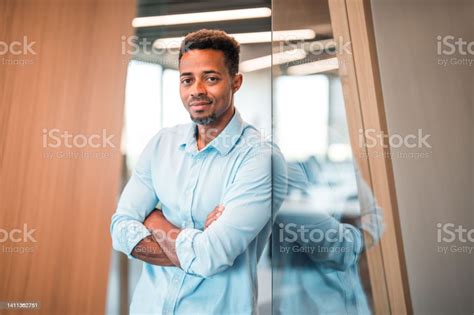 Business Portrait Of Confident Black Man With Arms Crossed Stock Photo