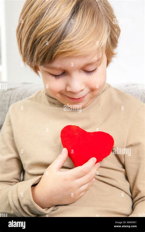 ï¿½ï¿½ute Young Boy With A Red Heart Stock Photo Alamy