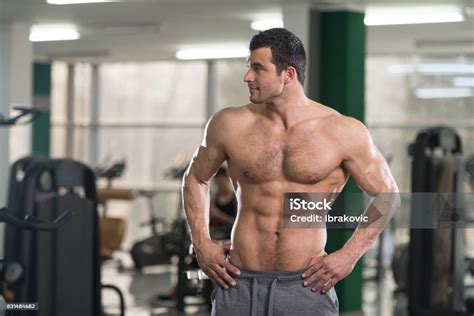 Hairy Muscular Man Flexing Muscles In Gym Stock Photo Download Image
