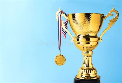 Golden Trophy Cup And Medal On Background Space For Text Stock Photo