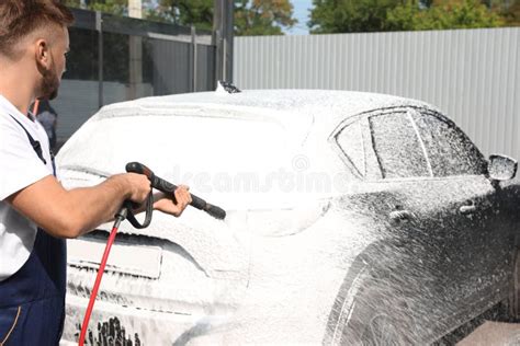 Young Driver Man Washing His Car With Contactless High Pressure Water