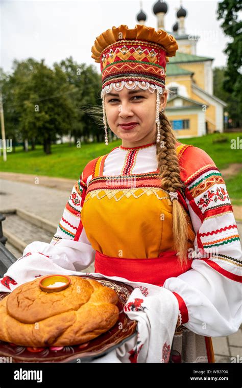 Russia Uglich Girl In Traditional Russian Costume With A Long Braid To Prepare To Meet