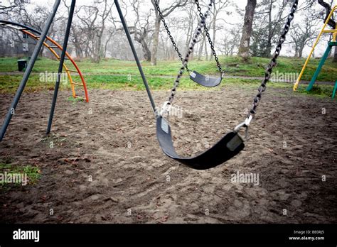 Empty Swings In Playground Stock Photo Alamy