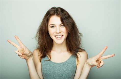 Premium Photo Lovely Young Woman Showing Victory Or Peace Sign