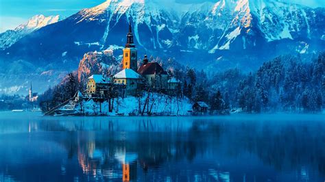 Castle In Middle Of Lake Around Snow Covered Mountains And