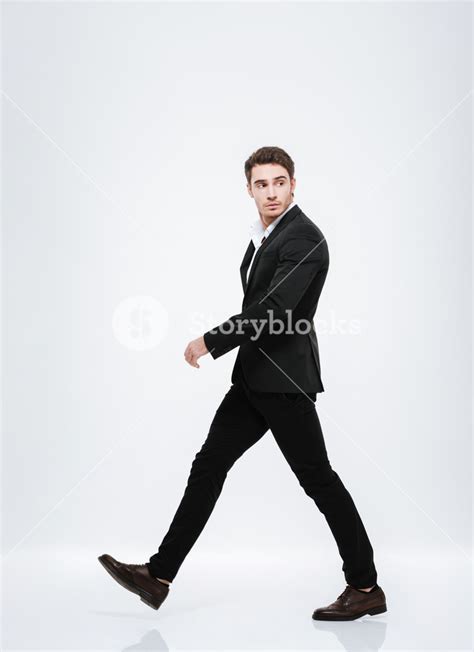 Side View Portrait Of A Businessman Walking And Looking Away Isolated