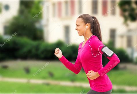 Smiling Young Woman Running Outdoors — Stock Photo © Syda