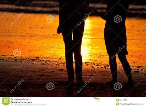 Silhouettes Of Couple At The Beach During Sunset Stock Image Image Of