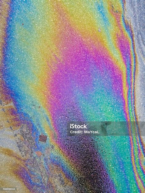 Multi Colored Oil Spill On Asphalt Road Abstract Background Stock Photo