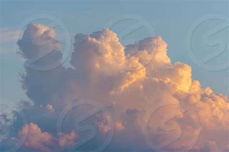 Beautiful Colored Dramatic Cumulus Fluffy Clouds On Blue Sky At Sunset