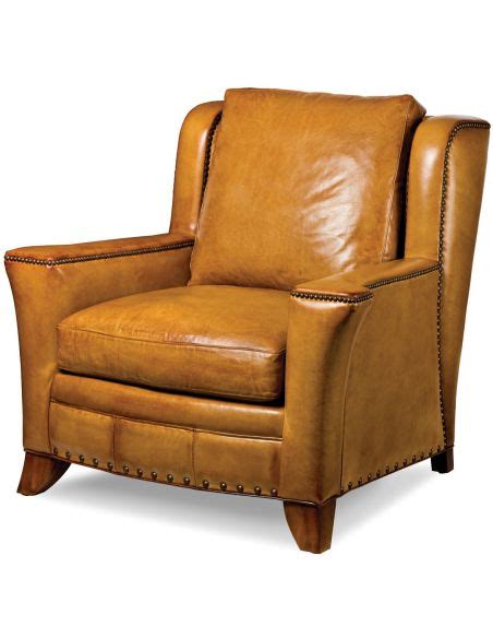 A weathered finish and antiqued brass. Leather armchair with nailhead trim - Bernadette Livingston
