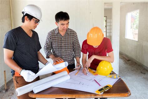 Engineer And Architect Discussing With Foreman About Project In