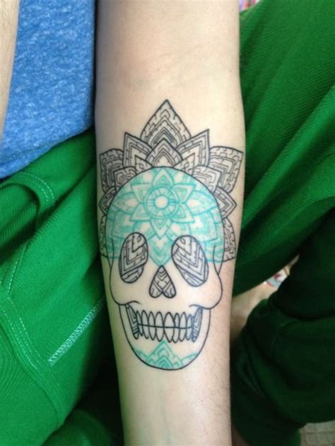 A Person With A Skull Tattoo On Their Arm