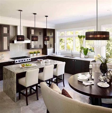 A Modern Kitchen And Dining Room Are Shown In This Image With Dark
