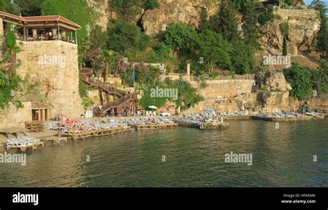 Mermerli Beach And Restaurant With The City Walls In Antalyas Oldtown