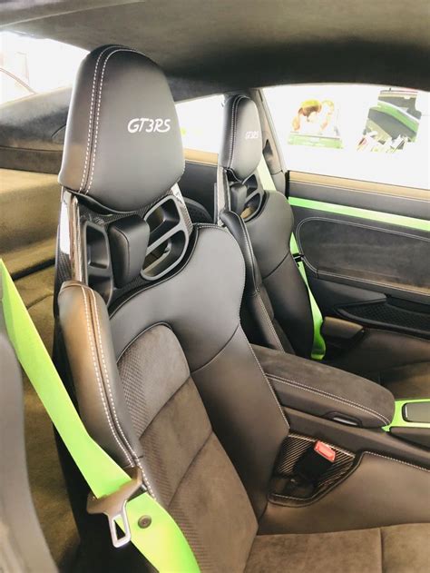The Interior Of A Car With Black Leather And Lime Green Trim Including