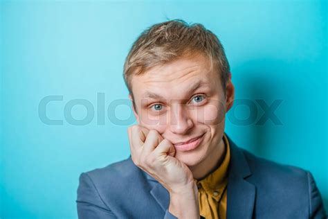 Closeup Portrait Of A Man Resting Chin On Hand Brows Raised And