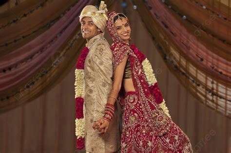 Portrait Of Newly Married Indian Couple Holding Hands Photo Background And Picture For Free