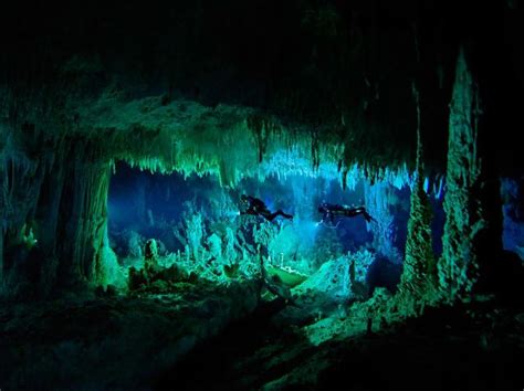 The Cave Is Lit Up With Green And Blue Lights