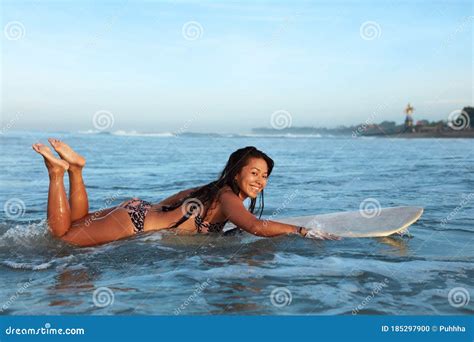 Beautiful Surfer Girl Surfing Woman On White Surfboard In Ocean Tanned Brunette In Bikini