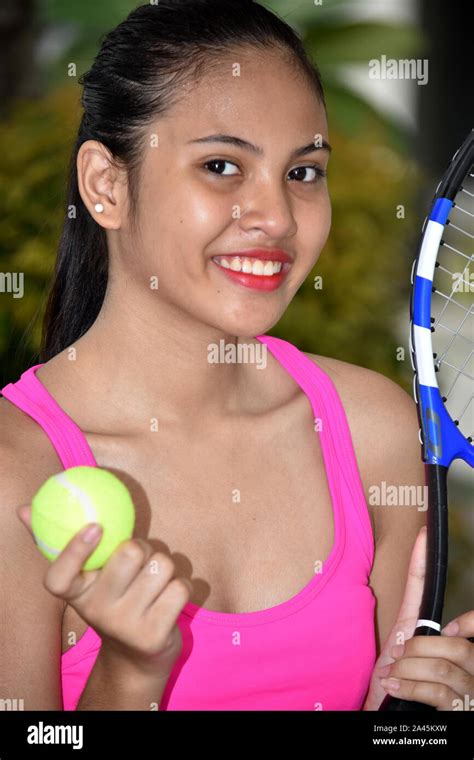 Pretty Asian Female Tennis Player Smiling With Tennis Racket Stock