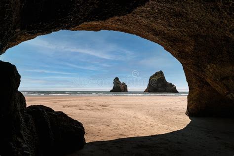 View From The Cave Of Wharariki Beach In New Zealand With A Woman