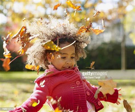 Black Kids Playing In Leaves Photos And Premium High Res Pictures