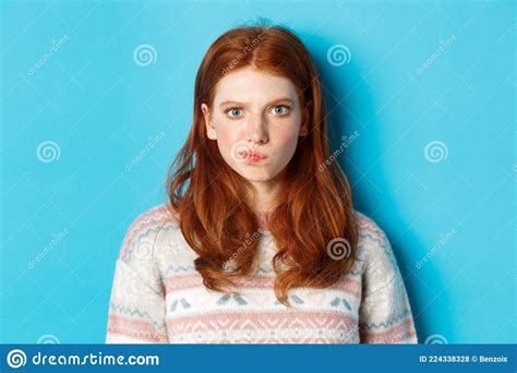 Close Up Of Serious Looking Girl Thinking Staring At Camera Troubled And Grimacing Making Hard