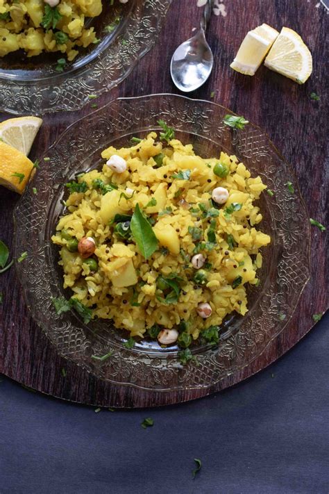 Image Of A Glass Plate Containing Instant Pot Poha With Potatoes And
