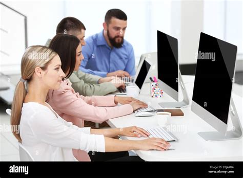 People Working On Computers At A Office Stock Photo Alamy