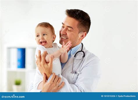 Happy Doctor Or Pediatrician With Baby At Clinic Stock Photo Image Of