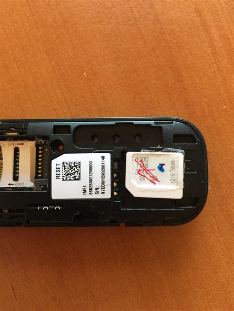 Push the tray opener pin in the tray hole and slide the tray out. how to Insert sim card 4GX USB Wifi plus Hawuei 83... - Telstra CrowdSupport - 608670