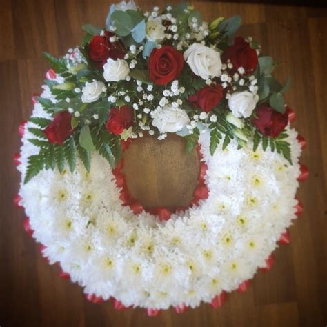 Funeral Tribute Based In White With A Red Ribbon Edge Complimented