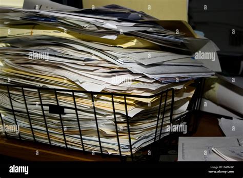 A pile of papers and file folders stacked to overflowing in a black ...