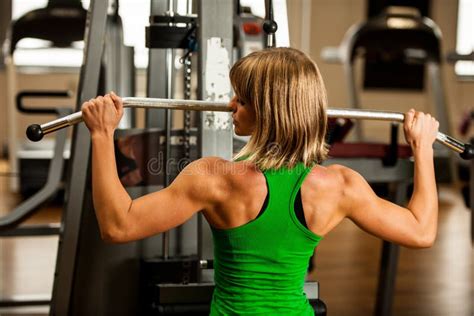 Beautiful Muscular Fit Woman Exercising Building Muscles In Fitness Gym