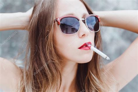 Young Girl Smoking Cigarette — Stock Photo © Sergeycauselove 96924740
