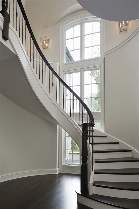 Winnetka Sun Filled Dramatic Curved Staircase With 30 Window Backdrop