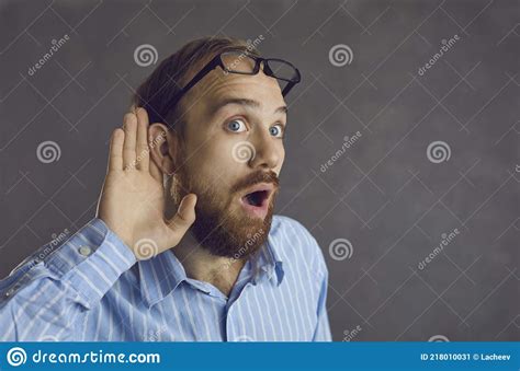 Curious Man Listening With Hand At Ear Eavesdropping On A Shocking
