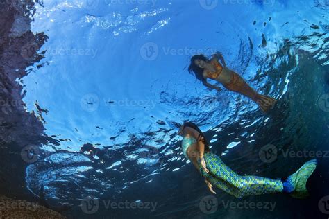 Two Mermaid Swimming Underwater In The Deep Blue Sea 17367438 Stock