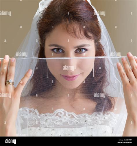 Studio Shots Of A Gorgeous Young Bride In Traditional White Dress And