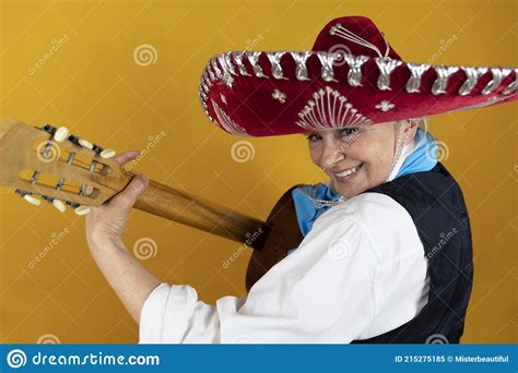 Funny Portrait Of Mature Woman A Lady Playing The Guitar Dressed As A Mexican Mariachi Stock
