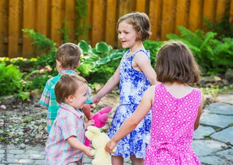 Children In A Circle Playing Ring Around The Rosie Stock Photo And